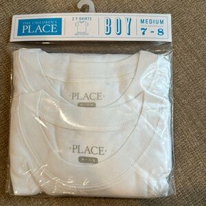 2 T shirts. White. Medium size 7-8